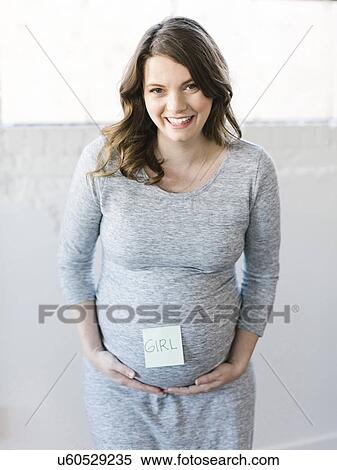 Portrait of smiling pregnant woman with adhesive note on belly View Large Photo Image Stock Photography - Portrait of smiling pregnant woman with adhesive note on belly. Fotosearch
