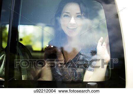 Picture - Portrait of smiling woman sitting in bus. Fotosearch