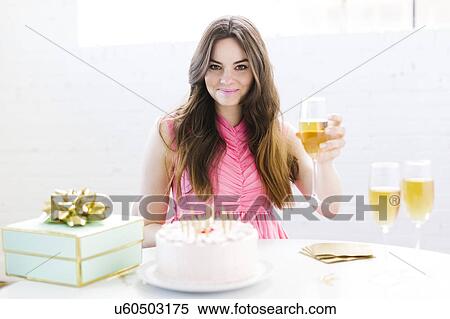 Stock Photography - Portrait of woman at birthday party. Fotosearch