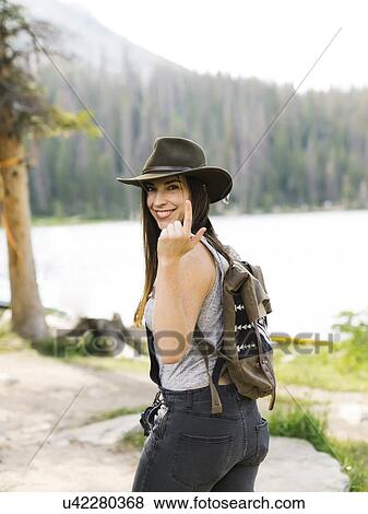 Stock Photo - Portrait of woman hiking by lake. Fotosearch