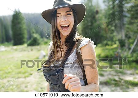 Stock Image - Portrait of woman hiking in forest. Fotosearch