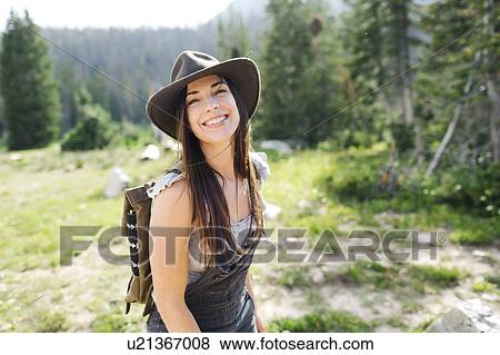 Stock Photo - Portrait of woman hiking in forest. Fotosearch
