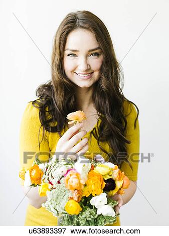 Portrait of woman holding flowers View Large Photo Image Stock Photo - Portrait of woman holding flowers. Fotosearch