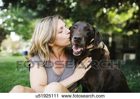 Portrait of woman kissing Labrador Retriever View Large Photo Image Stock Image - Portrait of woman kissing Labrador Retriever. Fotosearch