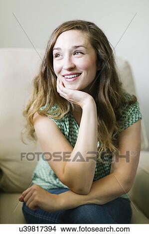 Portrait of woman sitting in living room View Large Photo Image Picture - Portrait of woman sitting in living room. Fotosearch