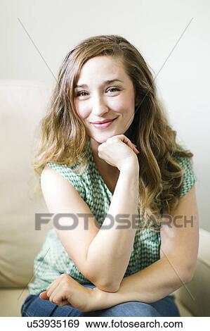 Portrait of woman sitting in living room View Large Photo Image Stock Photo - Portrait of woman sitting in living room. Fotosearch