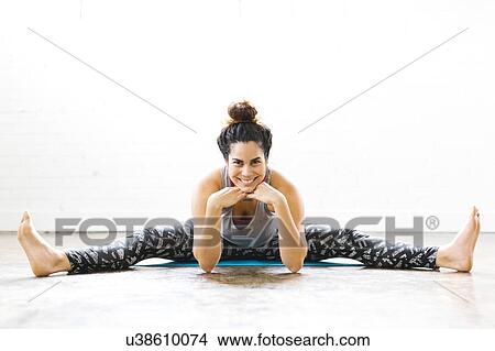 Portrait of woman stretching on exercise mat View Large Photo Image Picture - Portrait of woman stretching on exercise mat. Fotosearch