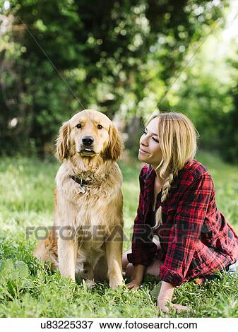 Stock Photo - Portrait of woman with dog in nature. Fotosearch