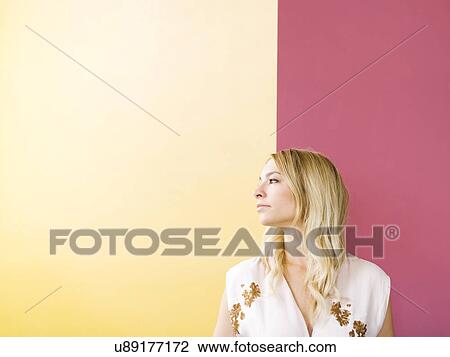 Stock Image - Portrait of young woman contemplating. Fotosearch