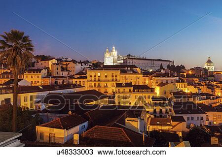 Stock Image - Portugal, Lisbon, Panorama of Lisbon Old Town at sunrise. Fotosearch