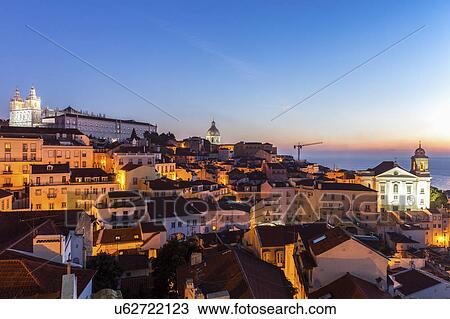 Stock Image - Portugal, Lisbon, Panorama of Lisbon Old Town at sunrise. Fotosearch