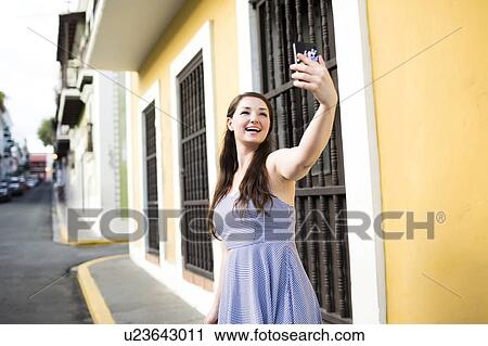 Puerto Rico, San Juan, Beautiful woman doing selfie on city street View Large Photo Image Stock Image - Puerto Rico, San Juan, Beautiful woman doing selfie on city street. Fotosearch