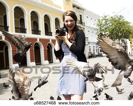 Puerto Rico, San Juan, Woman standing on street and photographing pigeons View Large Photo Image Stock Photo - Puerto Rico, San Juan, Woman standing on street and photographing pigeons. Fotosearch