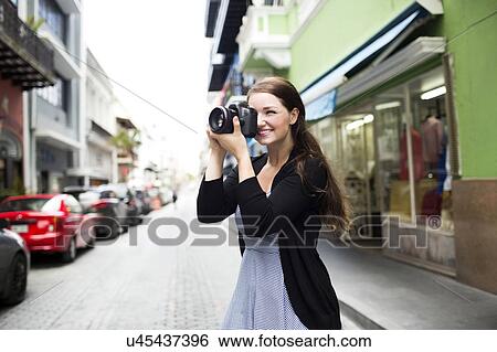Puerto Rico, San Juan, Woman photographing buildings on street View Large Photo Image Stock Photograph - Puerto Rico, San Juan, Woman photographing buildings on street. Fotosearch