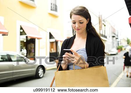Puerto Rico, San Juan, Woman with shopping bag walking in city street View Large Photo Image Stock Image - Puerto Rico, San Juan, Woman with shopping bag walking in city street. Fotosearch