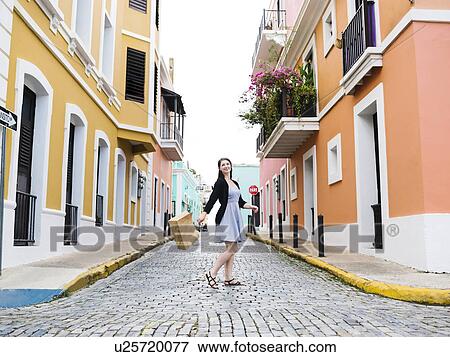 Puerto Rico, San Juan, Woman with shopping bag walking city streets View Large Photo Image Stock Photo - Puerto Rico, San Juan, Woman with shopping bag walking city streets. Fotosearch