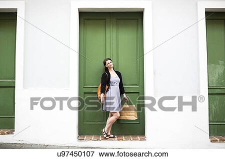 Stock Photo - Puerto Rico, San Juan, Woman with shopping bag walking city streets. Fotosearch