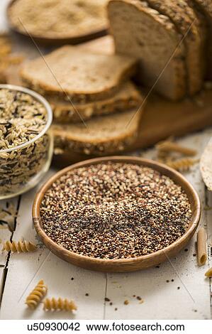 Quinoa in bowl and sliced brown bread in background View Large Photo Image Stock Image - Quinoa in bowl and sliced brown bread in background. Fotosearch