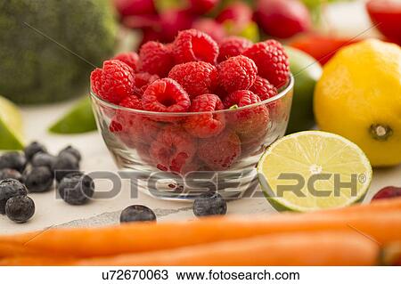 Raspberries in bowl surrounded by fruits and vegetables View Large Photo Image Stock Image - Raspberries in bowl surrounded by fruits and vegetables. Fotosearch