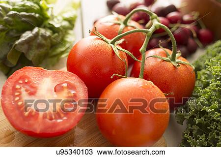 Red tomatoes on cutting board View Large Photo Image Stock Image - Red tomatoes on cutting board. Fotosearch