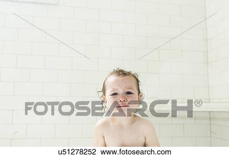 Stock Image - Sad boy (4-5) with wet hair in bathroom. Fotosearch