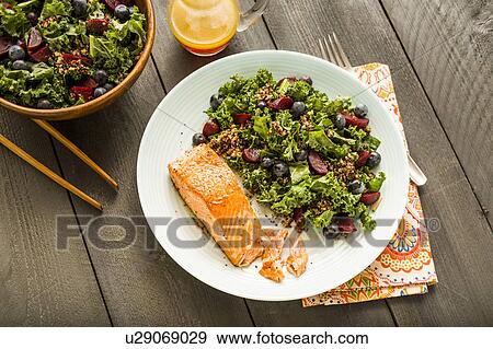 Stock Photo - Salmon with salad on plate. Fotosearch