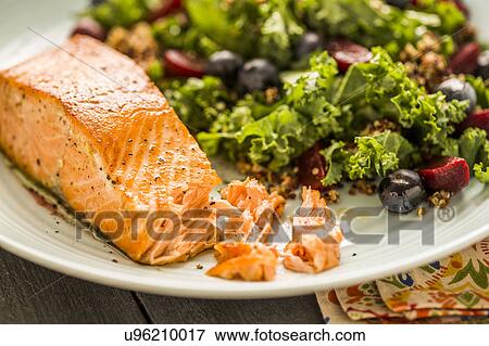 Stock Photo - Salmon with salad on plate. Fotosearch