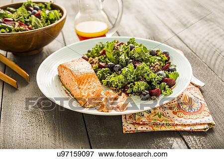 Stock Photo - Salmon with salad on plate. Fotosearch