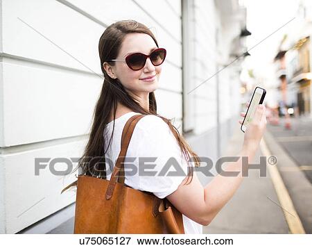 Stock Photo - San Juan, Puerto Rico, Beautiful woman walking city streets. Fotosearch