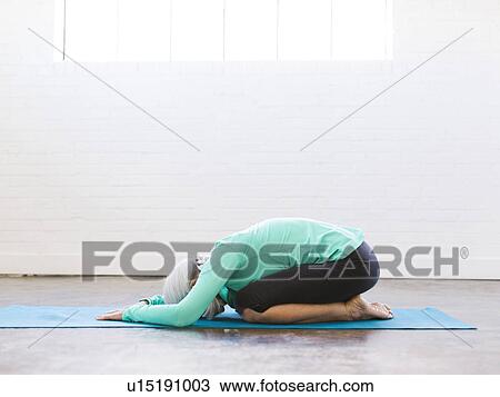 Senior woman practicing yoga on mat View Large Photo Image Stock Image - Senior woman practicing yoga on mat. Fotosearch