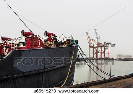 Stock Image - Ship moored in commercial dock. Fotosearch