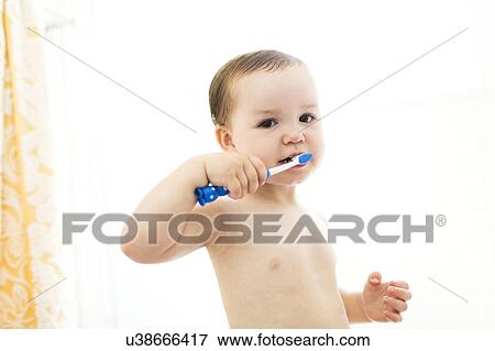 Stock Photo - Shirtless boy (4-5) brushing teeth. Fotosearch
