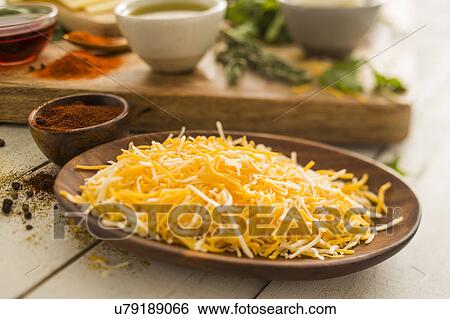 Shredded cheese on wooden plate View Large Photo Image Stock Photograph - Shredded cheese on wooden plate. Fotosearch