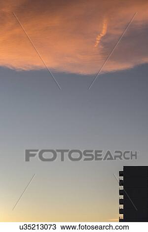 Stock Image - Silhouette of apartment building at dusk. Fotosearch