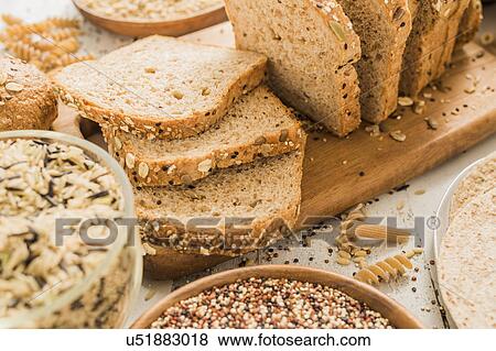 Sliced brown bread on cutting board View Large Photo Image Stock Photo - Sliced brown bread on cutting board. Fotosearch