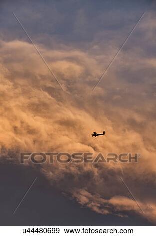 Small plane in sky with clouds in background View Large Photo Image Stock Photo - Small plane in sky with clouds in background. Fotosearch