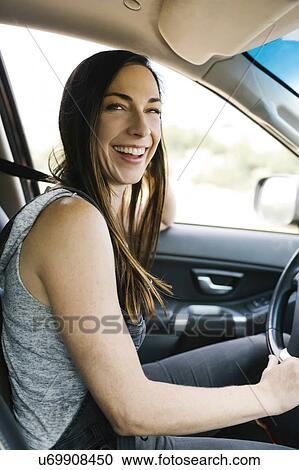 Smiling woman driving car View Large Photo Image Stock Image - Smiling woman driving car. Fotosearch