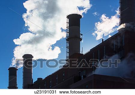 Stock Image - Smokestack releasing smoke. Fotosearch