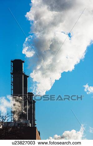Stock Image - Smokestacks releasing smoke. Fotosearch