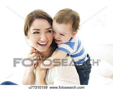 Stock Photo - Son (4-5) embracing mother. Fotosearch