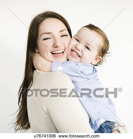 Stock Photograph - Son (4-5) embracing mother. Fotosearch