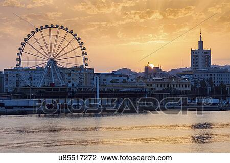 Stock Image - Spain, Andalusia, Malaga, Townscape at sunset. Fotosearch