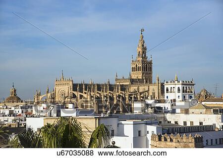 Stock Photo - Spain, Andalusia, Seville, Cityscape with Giralda Tower and cathedral. Fotosearch