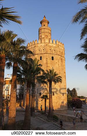 Stock Photo - Spain, Andalusia, Seville, Golden Tower in sunset light. Fotosearch