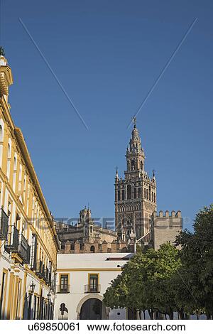 Stock Image - Spain, Andalusia, Seville, La Giralda bell tower of Seville cathedral. Fotosearch