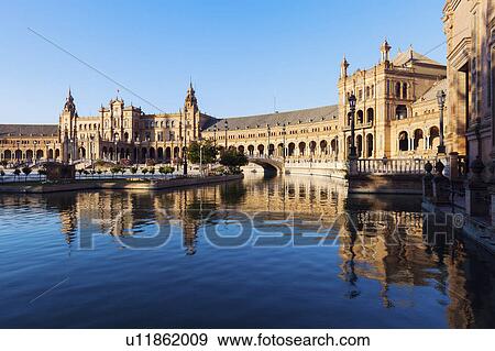 Stock Photo - Spain, Andalusia, Seville, Plaza de Espana reflecting in water surface. Fotosearch