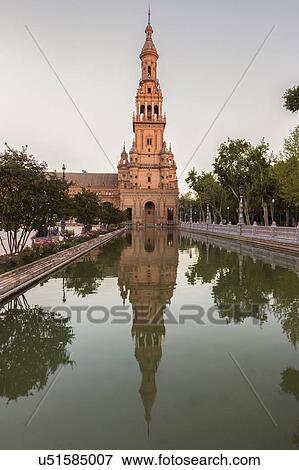 Stock Photo - Spain, Andalusia, Seville, Plaza de Espana, Tower reflecting in water surface. Fotosearch