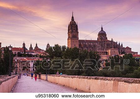 Stock Image - Spain, Castile and Leon, Salamanca, Catedral Nueva de Salamanca and Roman Bridge in long exposure. Fotosearch
