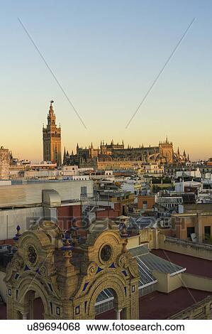 Stock Photo - Spain, Seville, Cityscape with Cathedral of Seville at sunset. Fotosearch