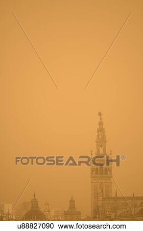 Stock Image - Spain, Seville, Giralda at foggy day. Fotosearch